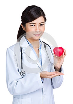 Female doctor hodling heart shape squeezing ball