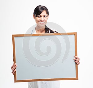 Female doctor holding blank white board