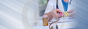 Female doctor holding a blister pack of pills. panoramic banner