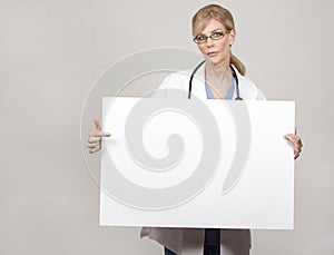 Female doctor holding board