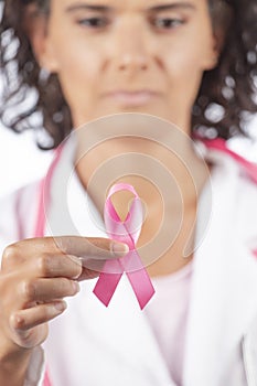 Female doctor holding breast cancer ribbon