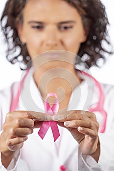 Female doctor holding breast cancer ribbon