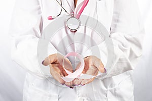 Female doctor holding breast cancer ribbon