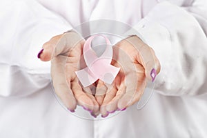 Female doctor holding breast cancer ribbon