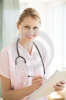 Female Doctor Holding Clipboard And Pen In Hospital