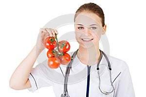Female doctor holding healthy tomatoes.