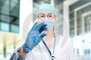 Female doctor holding a pill in hand. Doctor presents a medicine and treatment