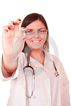 female doctor holding a pill in her hand