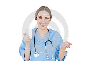 Female doctor holding a plastic cup and blue pills