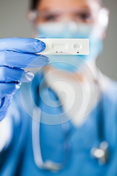 Female doctor holding Rapid Diagnostic Test serological test kit