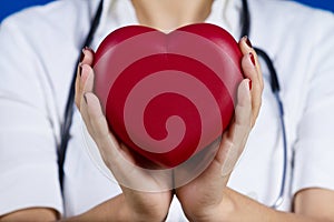 Female doctor holding red heart