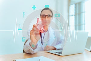 Female Doctor is Holding Stethoscope for Heart Model Check Up in Laboratory, Close Up of Scientist Practitioner Analyzing Health photo