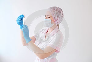 Female doctor holding syringe and COVID-19 vaccine. Healthcare And Medical concept