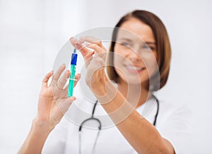 Female doctor holding syringe with injection