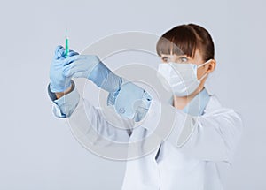 Female doctor holding syringe with injection