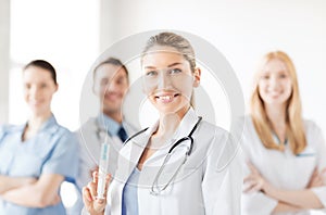 Female doctor holding syringe with injection