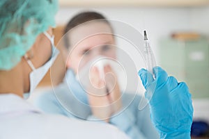 Female doctor holding syringe ready to make injection