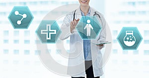 Female doctor holding tablet with medical interface hexagon icons