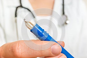 Female doctor is holding tweezers with a tick