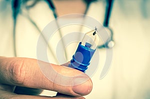 Female doctor is holding tweezers with a tick - retro style