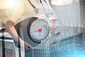 Female doctor holding a weight scale; multiple exposure