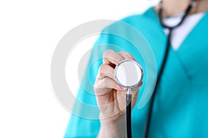 Female doctor holds stethoscope head closeup. Physicians ready to examine and help patient. Medical help and insurance