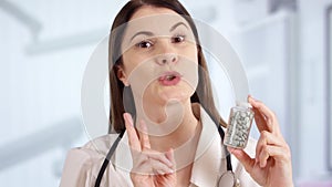 Female doctor in hospital room talking with patient via messenger app. Woman physician at work