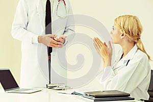 Female doctor at hospital talking to her partner.