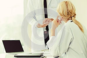 Female doctor at hospital talking to her partner.