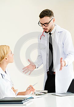 Female doctor at hospital talking to her partner.