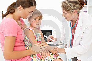 Female doctor injecting child photo