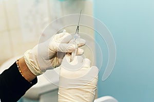 Female doctor injecting medical antidote syringe from glass ampoule close-up, virus cure liquid, hospital healthcare concept