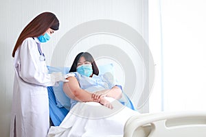 A female doctor injects an injection on the shoulder to an obese female patient to treat disease.