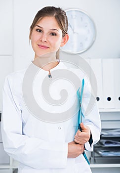 Female doctor in lab coat with clipboard