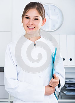 Female doctor in lab coat with clipboard