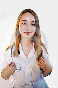 Female doctor in lab coat with Stethoscope against white background.