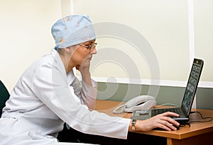 Female doctor with laptop photo