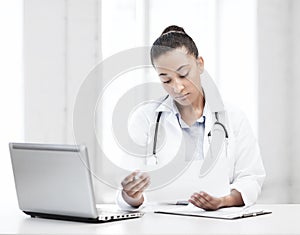 Female doctor with laptop pc