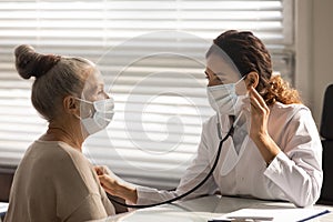 Female doctor listen to senior patient heart