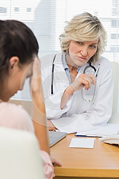 Female doctor listening to patient with concentration