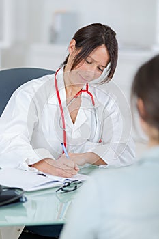 Female doctor listening to patientin office