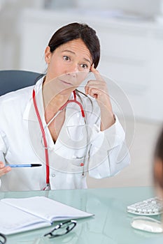 Female doctor listening to patientin office