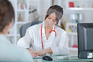 Female doctor listening to patientin office