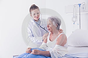 Female doctor listening to a patients lungs