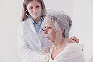 Female doctor listening to a patients lungs