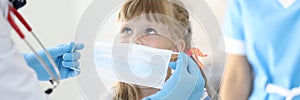 Female doctor with little child put on protective mask portrait photo