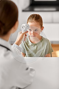 female doctor and little girl patient at clinic