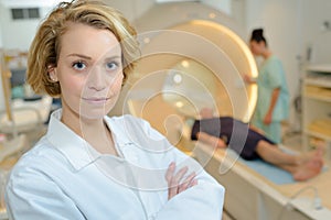 Female doctor looking at camera in mri room hospital