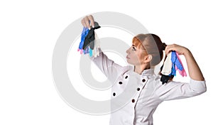Female doctor looking at colored disposable gloves in her hands, isolated on white.