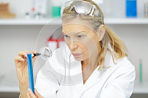 Female doctor looking through loupe